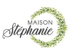 Logo featuring the text "Maison Stéphanie" surrounded by a green leaf wreath.
